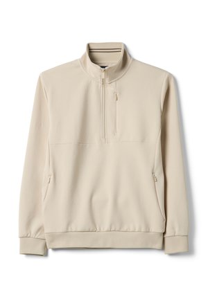 Sudadera beige con cremallera hasta el cuarto, cuello alto, mangas largas, puños elásticos y bolsillos con cremallera en el pecho y los costados.