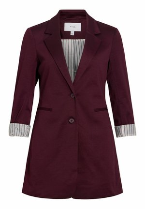 Blazer bordeaux sur mesure avec deux boutons à l'avant, col à revers cranté, manches retroussées dévoilant une doublure blanche à fines rayures verticales.