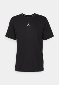 Schwarzes T-Shirt aus Baumwolle mit Rundhalsausschnitt. Verfügt über ein auf der Brust gedrucktes weißes Jordan-Logo, kurze Ärmel und einen lockereren Schnitt.