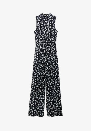 Schwarzer Jumpsuit mit weißen Punkten, ärmelloses Design, hoher Ausschnitt, tailliert und mit weiten Hosenbeinen. Glattes Material mit leichtem Glanz.