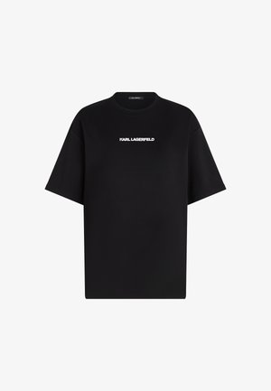 Mustan värinen ylisuurikokoinen t-paita, joka on valmistettu puuvillasta ja jossa on crew-tila ja lyhyet hihat; etupuolella on valkoinen "KARL LAGERFELD" -logo.