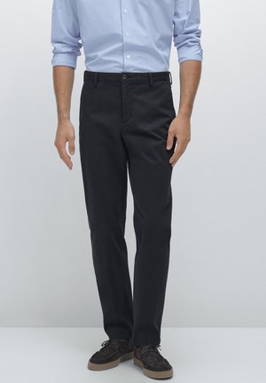 Black cotton chino pants with a flat front, belt loops, and a single button closure. Smooth texture, tailored fit, and straight leg design.