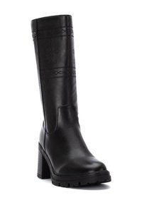 Bota de cuero negro hasta la rodilla con tacón cuadrado, con patrones de costura decorativos y una superficie texturizada. Suela de goma para agarre.