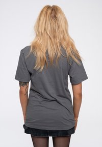 Grey cotton t-shirt with short sleeves, relaxed fit, and a smooth texture. Back view shows no patterns or additional details.