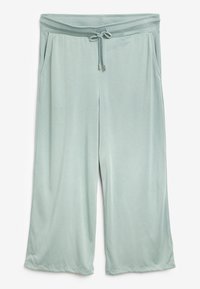 Lichtgroene wijde broek gemaakt van zacht materiaal. Voorzien van een tailleband met trekkoord, zijzakken en een ontspannen pasvorm met gladde naden.