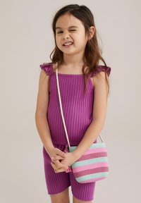 Purple ribbed romper with frill straps, paired with a multicolored striped woven bag featuring pink and blue tones.