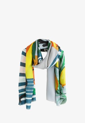 Scarf with colorful abstract patterns including stripes, green leaves, lemons, and bold shapes in yellow, orange, blue, and black tones.