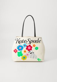 Sac en toile avec poignées noires, corps crème et motifs floraux colorés en rose, bleu, vert et jaune. Affiche le logo de la marque de manière bien visible.