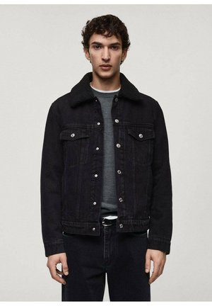 Black denim jacket with a soft, black collar, front button closure, two chest pockets, and a fitted design. Worn over a grey shirt.