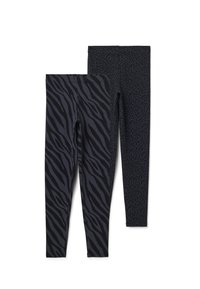 Zwarte leggings met twee dessins: een met een zebrastrippenpatroon en een met een subtiele luipaardprint, beide gemaakt van rekbare stof.