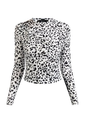 Hosszú ujjú felső rugalmas fehér anyagból, fekete pöttyös mintázattal, összegyűrt részlet a nyakvonalnál és cropped fazonú hem.