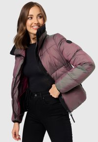 Padded bomber jacket in iridescent lavender with a high collar, black accents, zipper closure, and elastic cuffs. Textured, glossy finish.