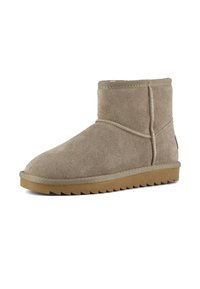 Stivaletto alla caviglia in suede beige con punta arrotondata, superficie testurizzata, dettagli cuciti e suola in gomma con un motivo a zigzag.