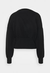 Svart kort sweatshirt med rund halsringning, långa puffärmar och en figursydd midja. Tillverkad av mjukt, texturerat tyg.