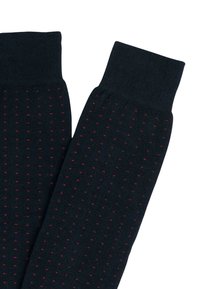 Calzini blu navy con un design a coste testurizzate, caratterizzati da piccoli punti rossi sparsi. I polsini sono spessi e lavorati a maglia per una maggiore durata.