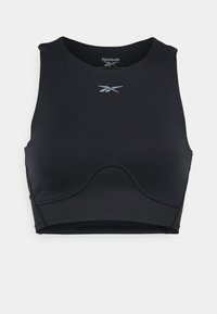 Črn športni nedrček iz elastičnega materiala, z okroglo ovratnikom, športno zasnovo z odprtim hrbtom in diskretnim srebrnim logotipom Reebok na sredini.