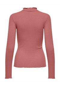 Maglia a maniche lunghe a coste in rosa polveroso. Presenta un collo a imbuto con bordo arricciato e una silhouette aderente. L'orlo ha un leggero bordo scallop.