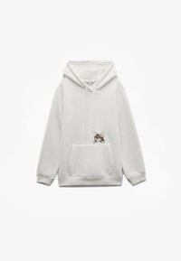 Sudadera blanca hecha de tela suave, con un bolsillo tipo canguro en la parte frontal y un diseño impreso de un gato en el lado izquierdo. Cuenta con capucha ajustable.