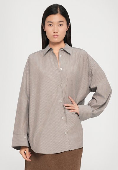 Striped button-up shirt in lightweight fabric, featuring a relaxed fit, pointed collar, and oversized sleeves with buttoned cuffs.