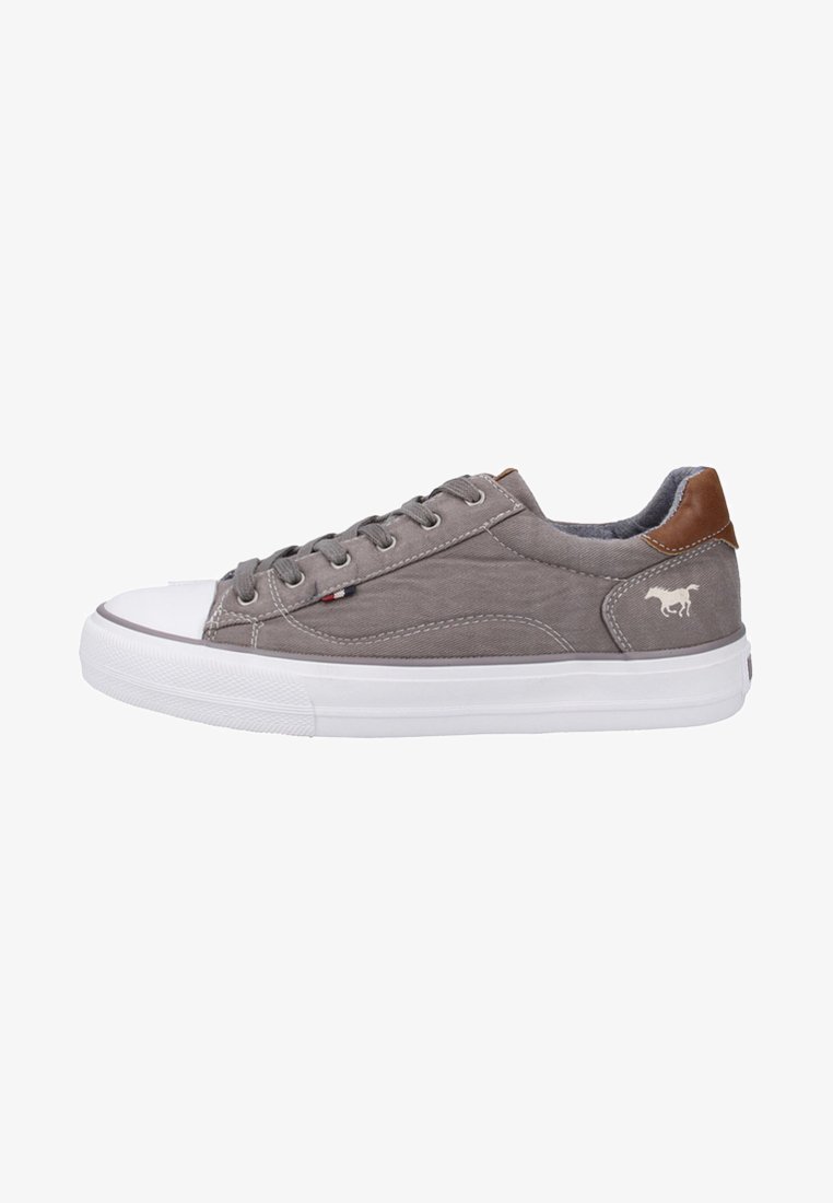 Gray canvas sneakers with a white rubber sole, brown leather heel accent, and side logo detail. Flat laces and padded collar for comfort.