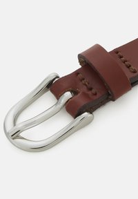 Cinturón de cuero marrón con una hebilla de metal plateado pulido, con costuras detalladas y una textura suave. Cuenta con un diseño clásico de doble lengüeta.