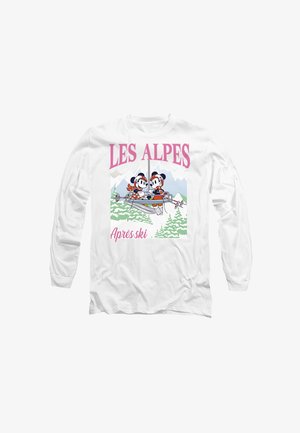 Weißes Langarm-T-Shirt mit Cartoonfiguren in einer Skilift, versehen mit dem Text "LES ALPES" und "Après ski" in pinken und grünen Akzenten.