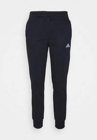 Pantalones de chándal azul marino hechos de tela suave. Cuentan con una cintura elástica con cordón, piernas ajustadas y un pequeño logotipo blanco de Adidas en el lado izquierdo.