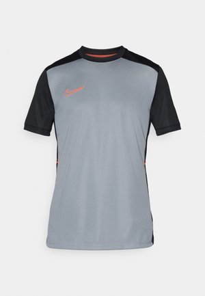 Gray athletic shirt with black sleeves, featuring a subtle texture, a round neckline, and an orange Nike logo on the chest.