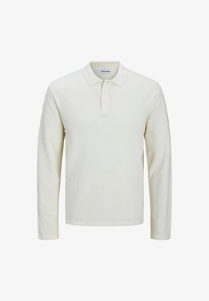 Cremfarbener Langarm-Polo-Shirt aus strukturiertem Stoff, mit einem Kragen und einer Drei-Knopf-Leiste, geradem Saum und seitlichen Schlitzen.