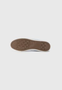 White sneaker sole with textured brown rubber. Features diamond-shaped patterns for grip and curved edges. Accents of blue on the sides.
