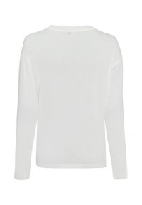 White long-sleeve shirt made of soft fabric. Features a round neckline, relaxed fit, and a small logo accent near the back neck.