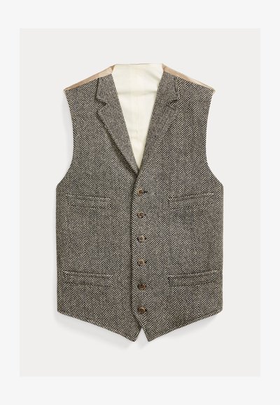 Καφέ και μπεζ γιλέκο σε σχέδιο ψαροκόκαλο με γιακά με σχισμή, έξι κουμπιά και δύο μπροστινές τσέπες. Εσωτερική επένδυση από μπεζ ύφασμα.