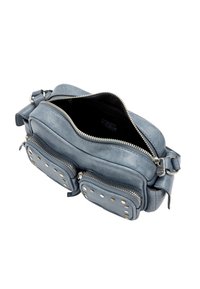 Szara skórzana torebka na ramię z dwoma zapinanymi na zamek kieszeniami, okrągłymi ćwiekami, gładką fakturą i regulowanym paskiem; górna część rozpięta, pokazująca wnętrze.