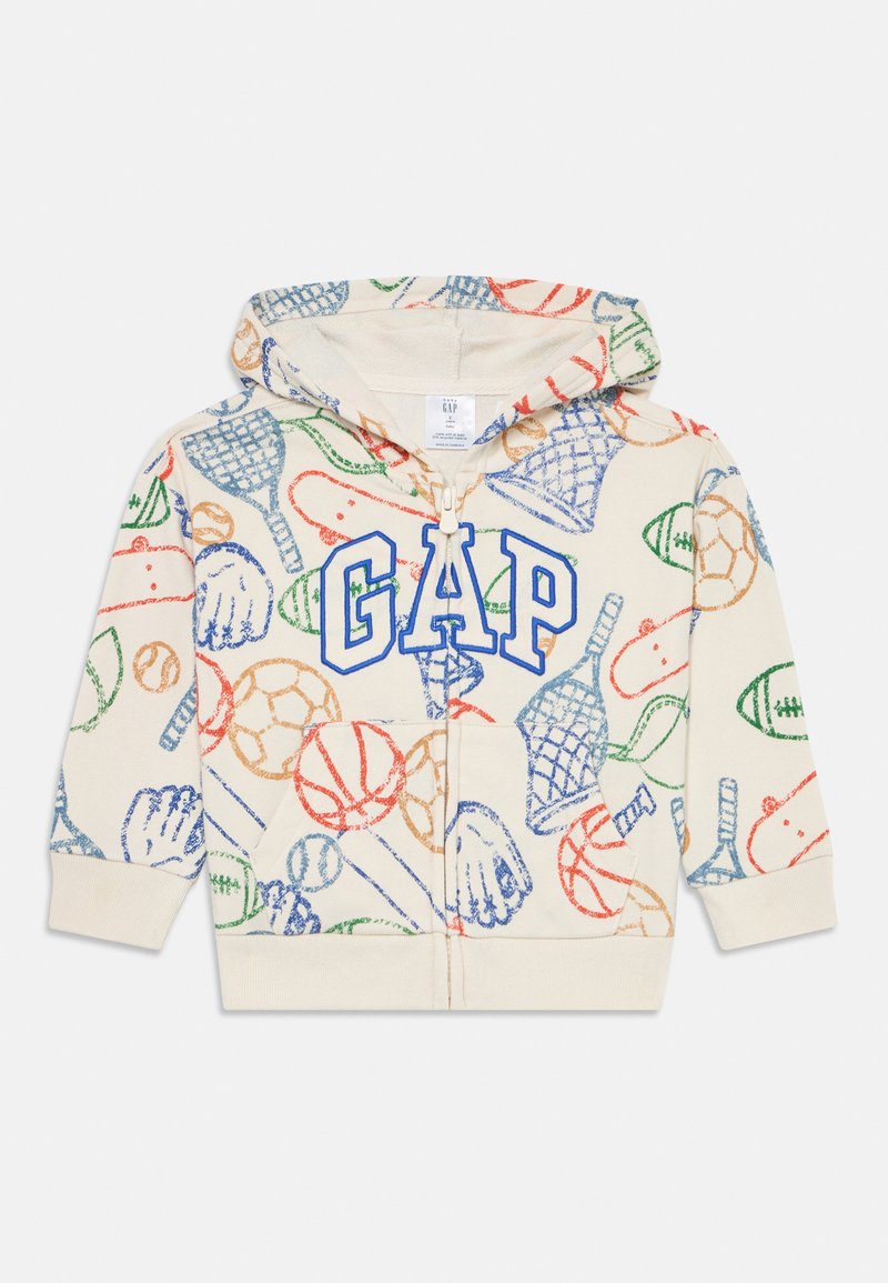 Felpa crema con logo "GAP" blu. Presenta stampe sportive colorate in rosso, verde e arancione. Zip intera, tasca a marsupio e cappuccio.