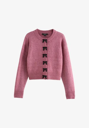 Crochet-style pink cardigan with ribbed cuffs and hem, featuring six black bow-shaped buttons down the front. Soft texture and cropped design.