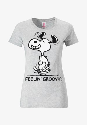 T-shirt en coton gris avec un chien en cartoon noir arborant une expression joyeuse, entouré du texte "FEELIN' GROOVY!" en lettres noires.