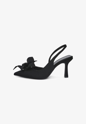 Black slingback heel with pointed toe, fabric upper, and a decorative flower accent. Features a slender heel and a smooth texture.