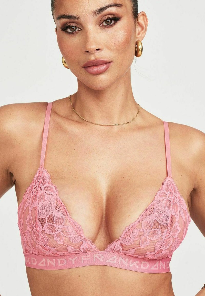 Roze kanten bralette met bloemenpatroon, verstelbare banden en een logoband. Doorzichtig materiaal accentueert het verfijnde ontwerp.