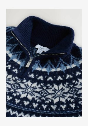 Navyblauwe gebreide pullover met een ritssluiting bij de kraag. Bevat witte en lichtblauwe sneeuwvlokpatronen. Zacht wollen materiaal, geribbelde kraag.