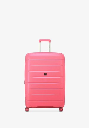 Hard-shell pink suitcase with textured vertical lines, retractable handle, and four spinning wheels for mobility. Compact and durable design.