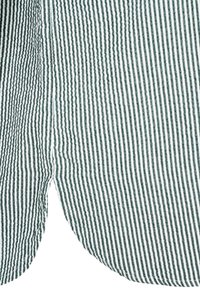 Green and white striped fabric with narrow vertical lines; soft texture, flowing design, and rounded hem at the bottom.