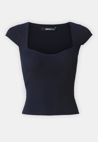 Mörkblå ribbad stickad topp med fyrkantig halsringning och ärmlösa ärmar, med vertikal detaljering för textur och passform.