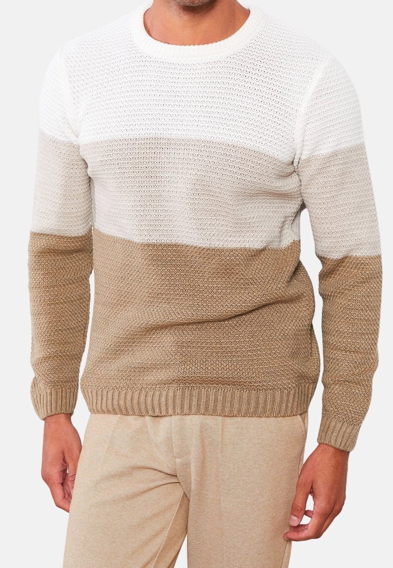 Pull en tricot présentant un motif à rayures horizontales en blanc, beige et marron clair. Tissu texturé avec bordures côtelées au col et aux poignets.