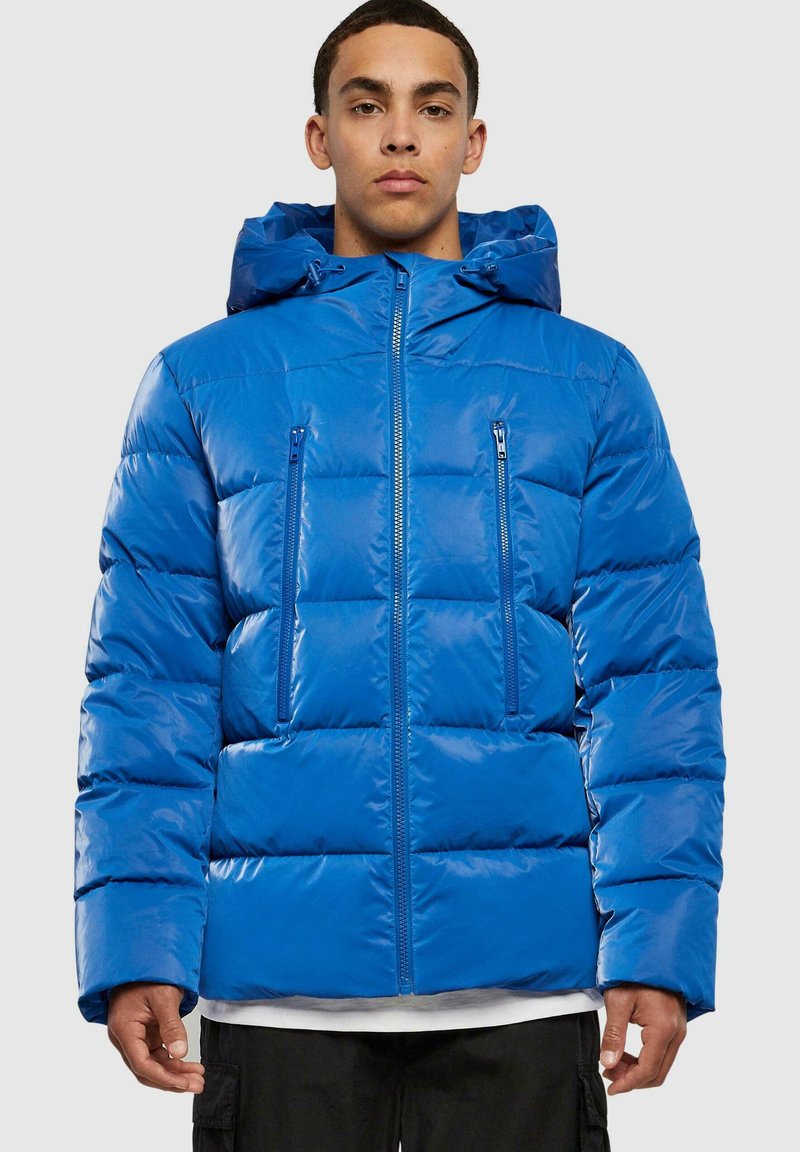 Blue padded jacket with a hood, glossy texture, two zippered chest pockets, and a front zipper. Features a boxy shape with quilted design.