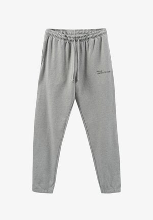 Grau Sweatpants mit elastischem Bund, Kordelzugdetails und seitlichen Bündchen. Besonders mit bedrucktem Text auf dem linken Oberschenkel. Weicher, leichter Stoff.