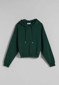 Grön beskuren hoodie med dragsko i huvan, långa ärmar och elastiska manschetter. Tillverkad av mjukt material, med en avslappnad passform.