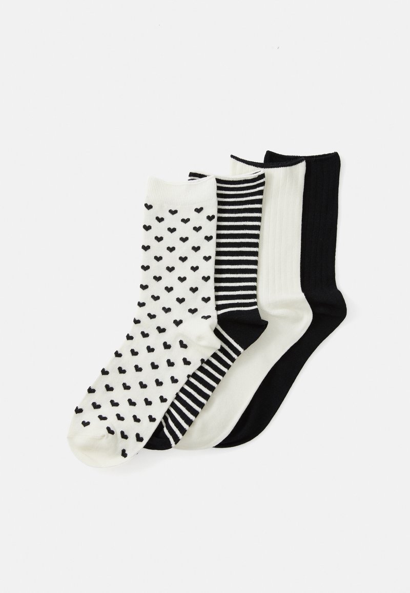 Three pairs of socks: one with small black hearts on white, one black and white striped, one solid black, and one solid white with ribbed texture.