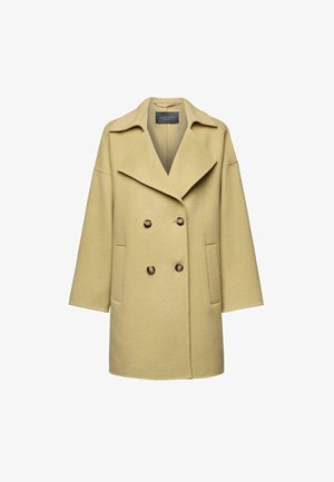 Dubbelzijdige jas van zachte, lichtgele wol, met een brede kraag, twee voorzakken en bruine knopen met een strak, minimalistisch ontwerp.
