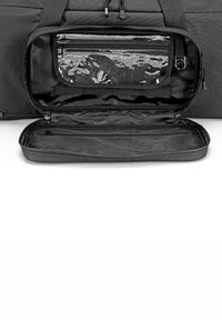 Black duffel bag interior with a mesh pocket and a transparent zippered compartment. Textured fabric and smooth lining. Opened and empty.