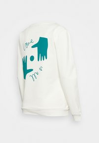 Sweatshirt blanc avec un graphique teal représentant deux mains et un cercle, accompagné du texte « love me » dans une police de caractère ludique. Texture douce.